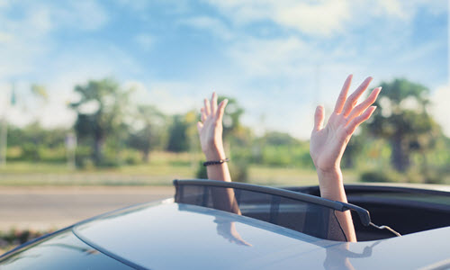 Lady Putting Hand Out Of Sunroof